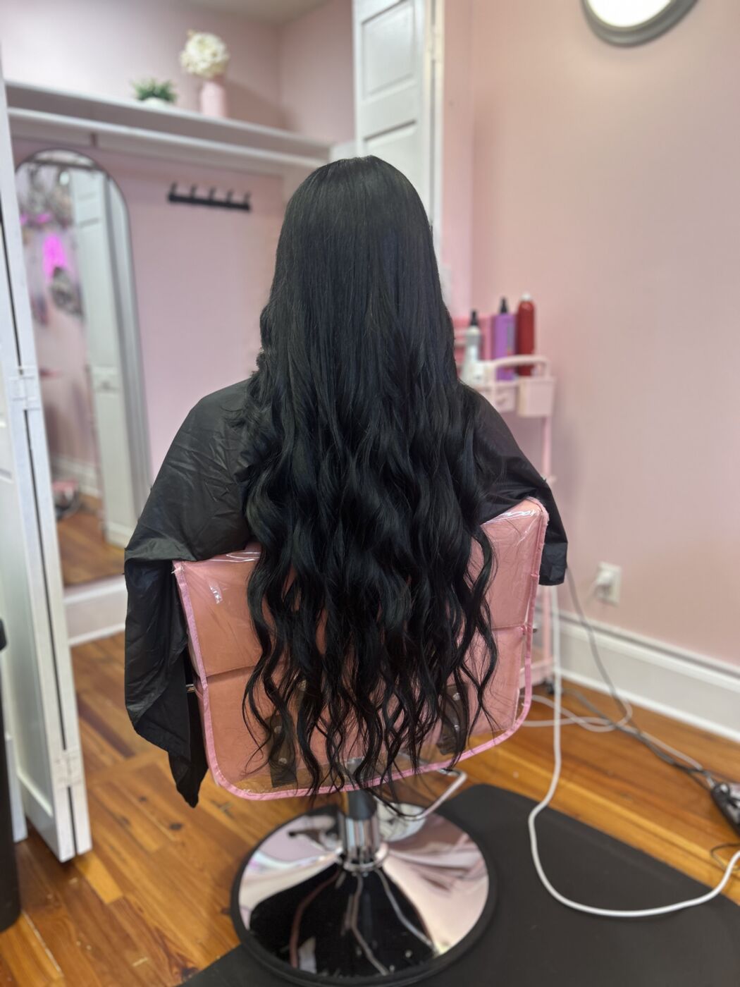 Glossy jet-black all-over color on extra-long hair by Kylie